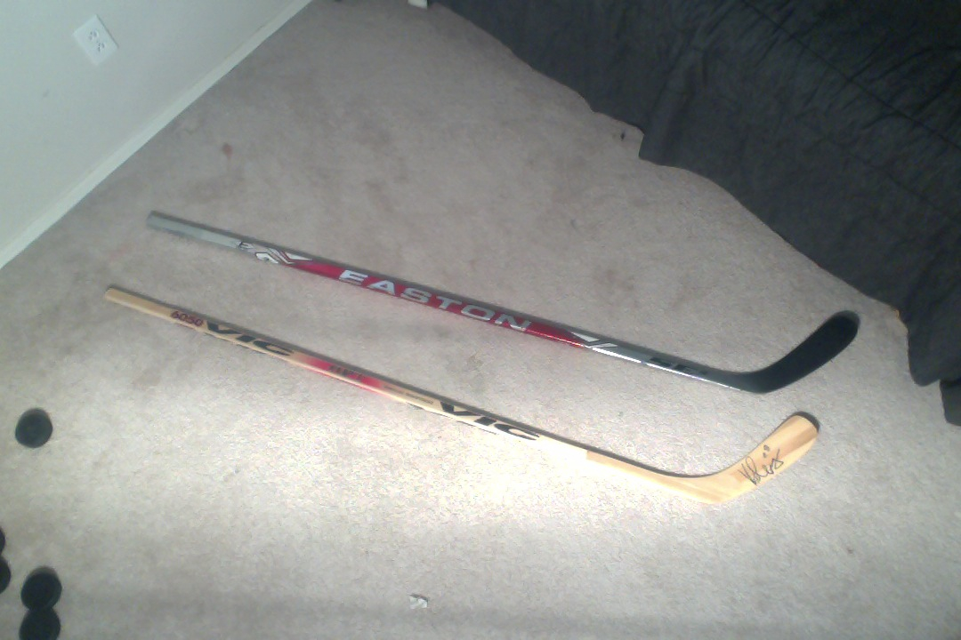 Two ice hockey sticks, one left one right